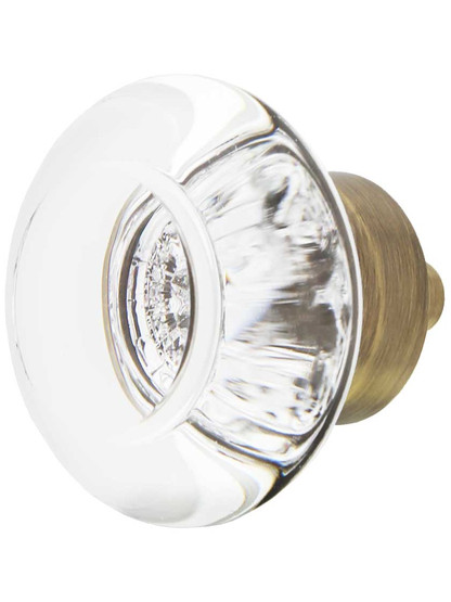 Round Clear Lead-Free Crystal Cabinet Knob - 1 3/8 inch Diameter in Antique Brass.